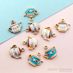 there are many charms that look like teapots on a pink and blue background