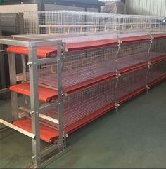 several cages are stacked on top of each other in an industrial area with metal racks