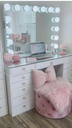 a pink chair sitting in front of a desk with a laptop on it