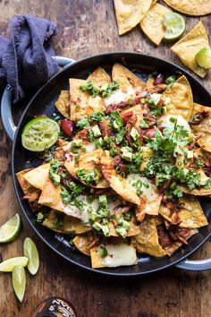 nachos with bacon, cheese and avocado are served on a plate