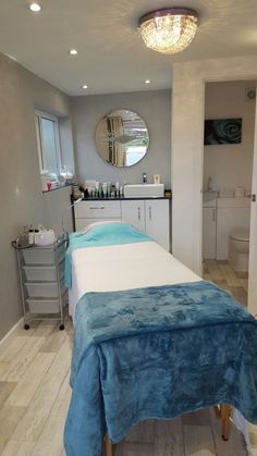 a spa room with a large blue blanket on the back of it's bed