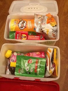 two plastic containers filled with snacks on top of a table