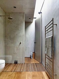 a bathroom with wooden flooring and white walls