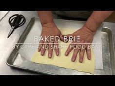 a person is making some food on a pan with the words baked brie in front of them