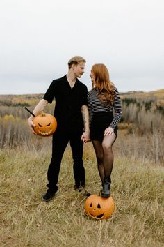 a man and woman holding pumpkins in their hands