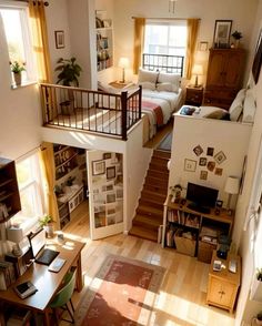 an overhead view of a living room and bedroom with stairs leading up to the second floor