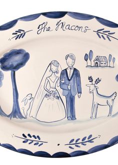 a blue and white plate with an image of a bride and groom holding hands, standing next to each other