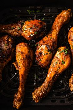 chicken legs on a grill with herbs and seasoning