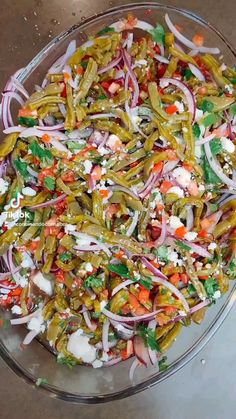 a glass bowl filled with lots of different types of food on top of a table