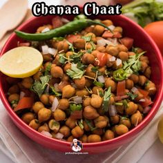 a red bowl filled with chickpeas and garnished with cilantro