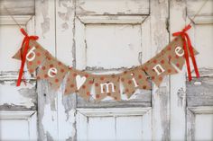 a banner that says be mine hanging from the side of a door with polka dots