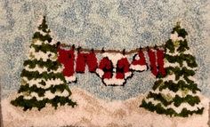 a knitted christmas banner hanging on a wall