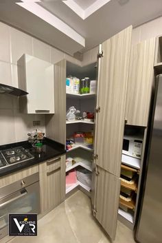 an open pantry in the corner of a kitchen