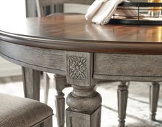 a close up of a wooden table with chairs