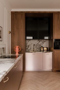 a kitchen with marble counter tops and wooden cabinets