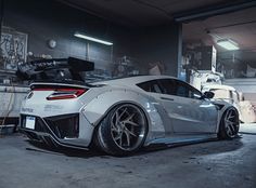 a white sports car parked in a garage