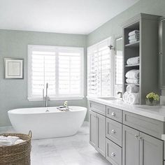 a large bathroom with a tub, sink and toilet in it's center area