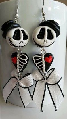 the skeleton earrings are decorated with black and white ribbon, red heart in the shape of a human head