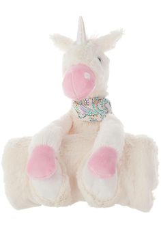 a white stuffed unicorn sitting on top of a white surface with pink and blue accents