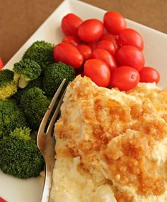 a white plate topped with mashed potatoes and broccoli next to a fork