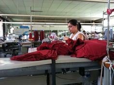 a woman working in a factory with red cloths