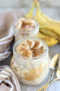 two jars filled with oatmeal and bananas on top of a wooden table