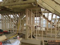 the inside of a house being built with wooden framing and roof trusses on it