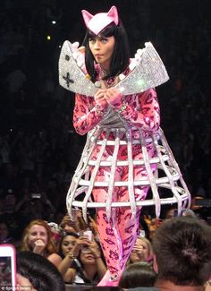 a woman in pink cat costume standing on stage