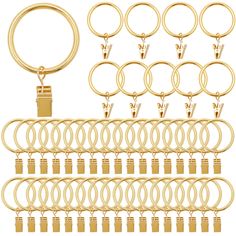 a bunch of gold colored metal rings and key chains with clippings on each side