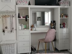 there is a white desk with a mirror and drawers in the room next to it