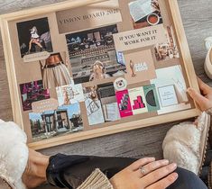 a woman sitting on the floor with her feet propped up next to a framed poster