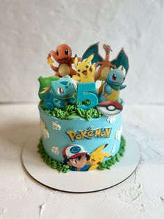 a pokemon themed birthday cake with pikachu and other characters