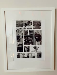 a black and white photo hanging on the wall with many different pictures in front of it