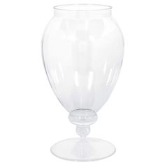 a clear glass vase sitting on top of a white table