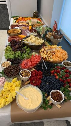 a buffet table filled with lots of different types of foods and desserts on it