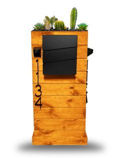 a wooden planter with plants growing out of it's sides and numbers on the side