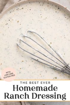 the best ever homemade ranch dressing in a white bowl with whisks on top