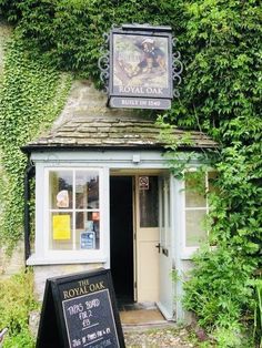 a small building with a sign in front of it that says the royal oak inn