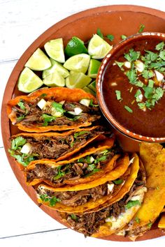 a plate filled with tacos, tortillas and salsa