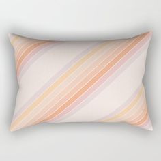 an orange and pink striped rectangular pillow on a white background with the word love written below it