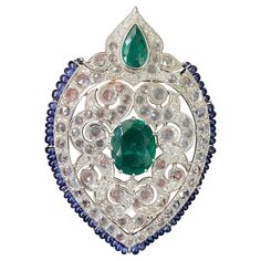 A stunning art-deco brooch, with Zambian Emeralds, Blue Sapphire beads, rose-cut White Sapphires and Diamonds - all set in solid 18K White Gold. The size of the brooch is around 7cm x 4.5cm. The Emeralds are natural, with great vivid green color and luster. The brooch can be customized, and made into a pendant-brooch as well. We provide free shipping. We accept returns. Please feel free to message for more information. Art Nouveau Jewellery, Art Deco Emerald, Sapphire Beads, Peacock Colors, Art Deco Brooch, Mughal Empire, Rene Lalique, Pins And Brooches, Nouveau Jewelry