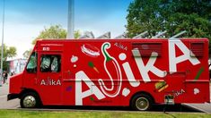 a red food truck parked in a parking lot