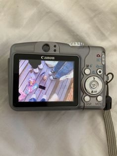 a digital camera sitting on top of a bed