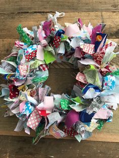 a wreath made out of scrap paper on top of a wooden table