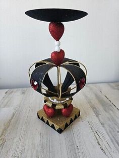 a small black and red object sitting on top of a wooden table