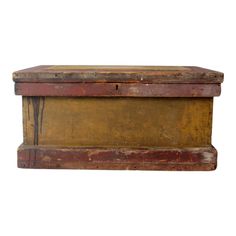 an old wooden box sitting on top of a white surface