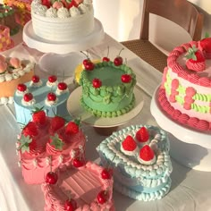 a table topped with lots of cakes and desserts on top of it's sides