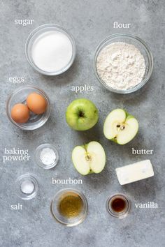 ingredients to make an apple pie laid out on a gray surface with words describing the ingredients