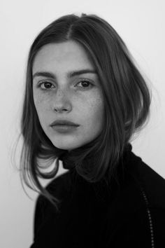 a black and white photo of a woman with freckled hair