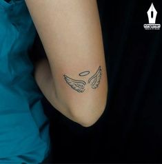 a woman's arm with an angel tattoo on the left side of her arm